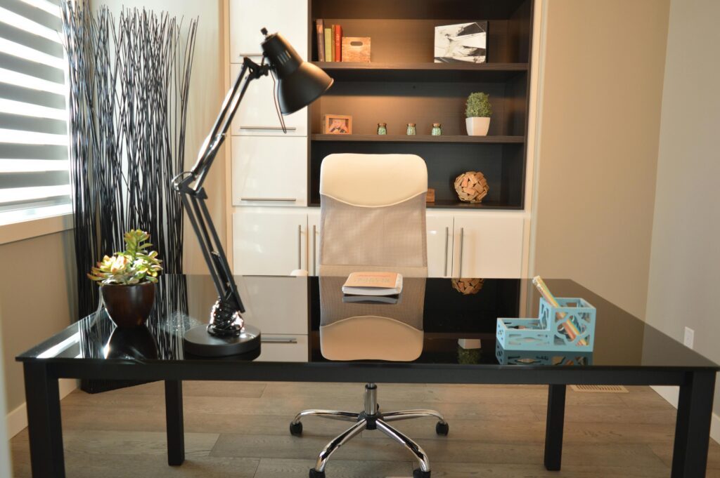 office-home-house-desk-159839-159839 Stylish modern office workspace featuring a black desk, lamp, and white chair with shelving.